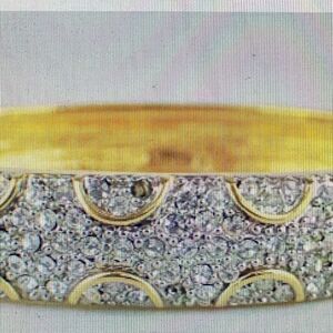 Vintage gold and crystal clamper bracelet . Missing one stone .